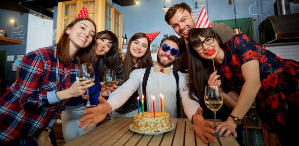 Birthday party with cake and candles friends at the restaurant b